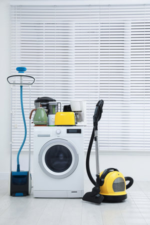 Different household appliances near window in room