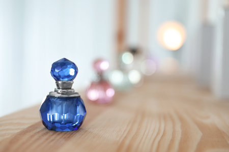 Perfume bottle on wooden shelf indoors. Space for textの写真素材