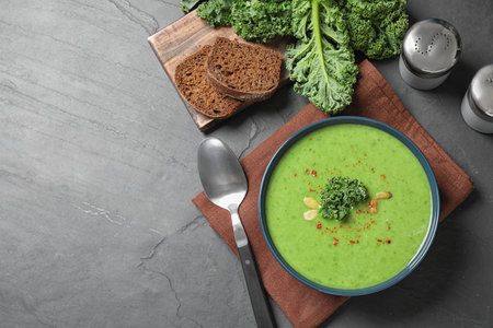 Tasty kale soup served on gray table, flat layの写真素材