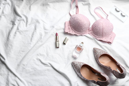 Flat lay composition with sexy women's underwear on white fabric, space for textの写真素材