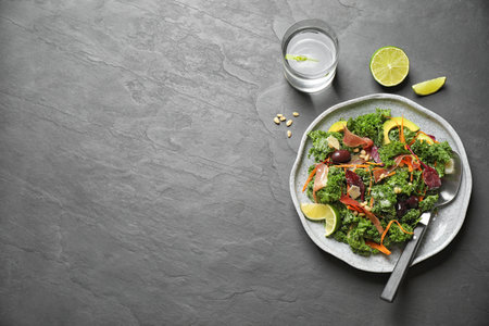 Tasty fresh kale salad on black table, flat lay. Space for textの写真素材