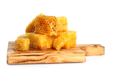 Board with fresh honeycombs isolated on whiteの写真素材