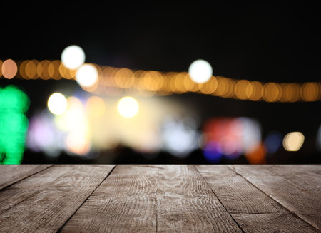 Empty wooden surface against blurred lights. bokeh effectの写真素材