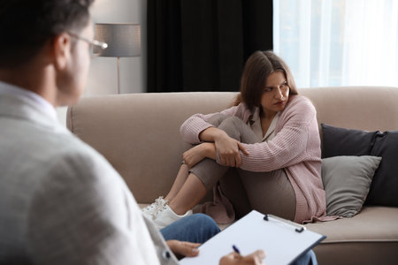 Professional psychotherapist working with patient in officeの写真素材