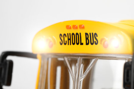 Yellow school bus on white background, closeup. Transport for studentsの写真素材