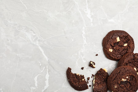 Delicious chocolate cookies on marble table, flat lay. Space for textの写真素材