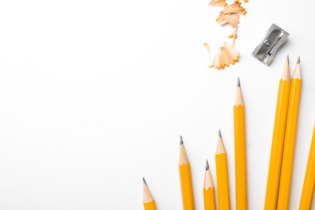 Graphite pencils, shavings and sharpeners on white background, top view. Space for textの写真素材
