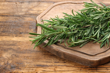 Bunch of fresh rosemary on wooden table, closeupの写真素材