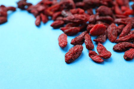 Dried goji berries on light blue background, closeupの写真素材