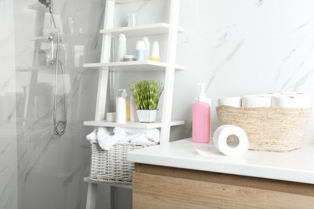 Toilet paper rolls on countertop in bathroomの写真素材