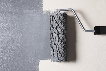 Painting beige wall with gray dye, closeup viewの写真素材