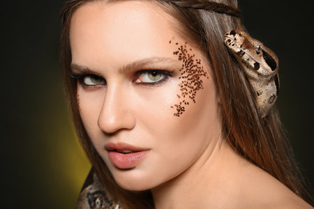 Beautiful woman with boa constrictor on color background, closeupの写真素材