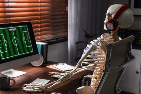 Human skeleton with headphones playing game indoorsの写真素材