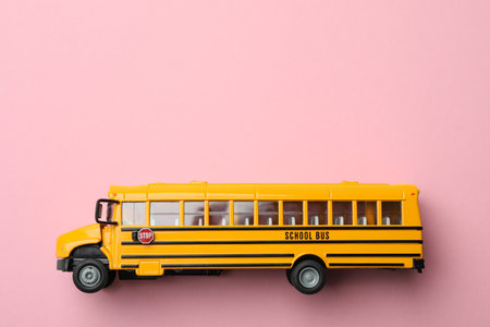 Yellow school bus on pink background, top view with space for text. transport serviceの写真素材