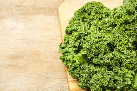 Fresh kale leaves on wooden table, closeup. Space for textの写真素材