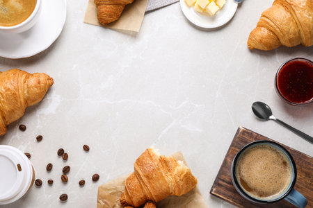 Flat lay composition with tasty croissants on light gray marble table, space for textの写真素材