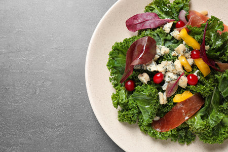 Tasty fresh kale salad on gray table, top view. Space for textの写真素材