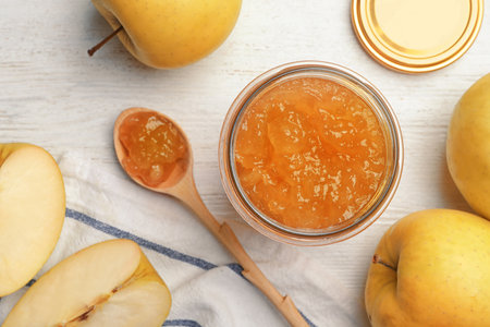 Homemade delicious apple jam on white wooden table, flat layの写真素材