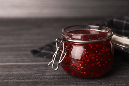Homemade delicious raspberry jam on gray wooden table. Space for textの写真素材