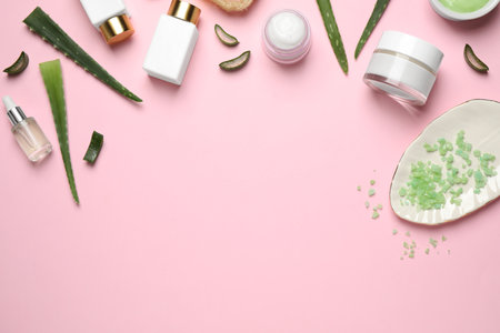 Flat lay composition with aloe vera and cosmetic products on pink background. Space for textの写真素材