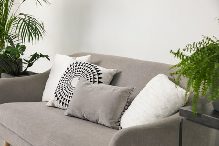 Soft pillows on gray sofa in living room