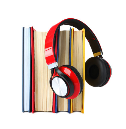 Books and modern headphones isolated on whiteの写真素材
