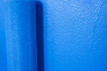 Painting wall with blue dye, closeup. interior renovationの写真素材