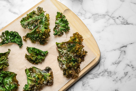 Tasty baked kale chips on marble table, top viewの写真素材