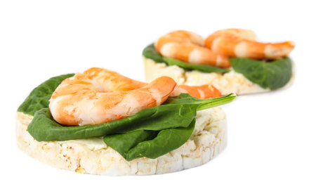Puffed rice cakes with shrimps and basil isolated on whiteの写真素材