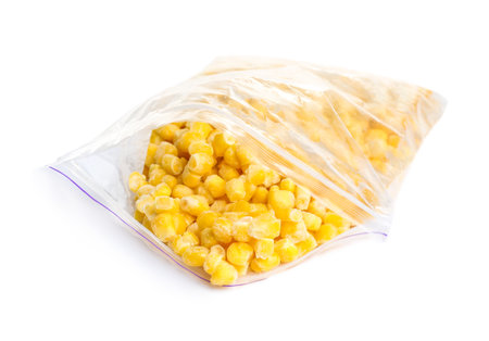 Frozen corn in plastic bag isolated on white. vegetable preservationの写真素材