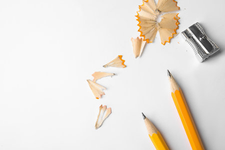 Graphite pencils, shavings and sharpeners on white background, top viewの写真素材