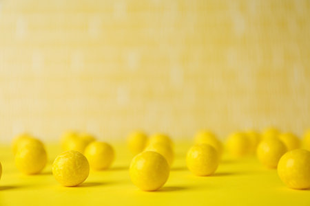 Delicious lemon chewing gums on yellow tableの写真素材