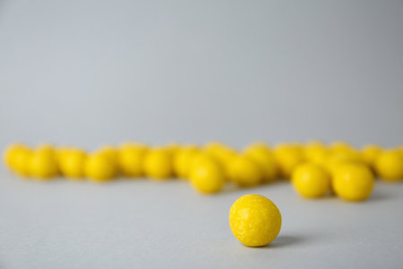 Delicious lemon chewing gums on light gray background, closeupの写真素材