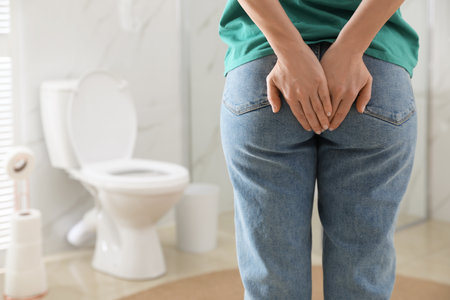 Woman suffering from hemorrhoid in rest room, closeupの写真素材