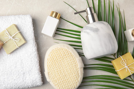 Flat lay composition with soap dispenser on marble background