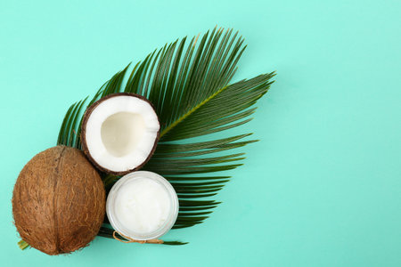 Flat lay composition with organic coconut oil on turquoise background. healthy cookingの写真素材