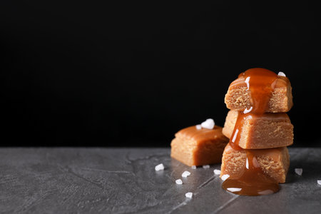 Salted caramel on gray table against black background. Space for textの写真素材
