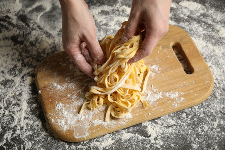 Woman preparing pasta at table, above viewの写真素材