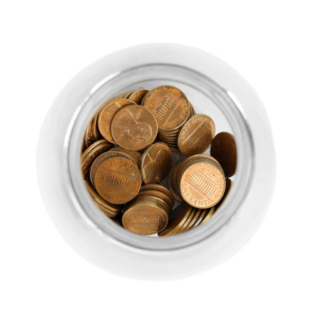 Glass jar with coins isolated on white, top view