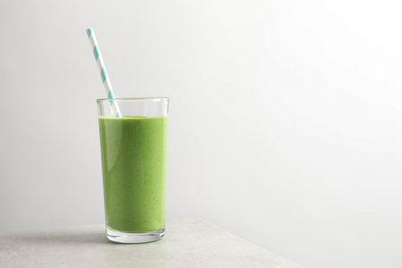 Tasty kale smoothie on light gray marble table, space for textの写真素材