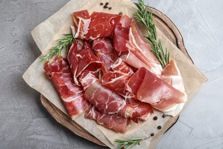 Tasty prosciutto on gray table, top viewの写真素材