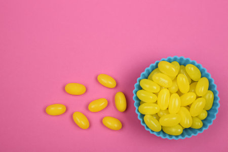 Delicious lemon drops on pink background, flat layの写真素材