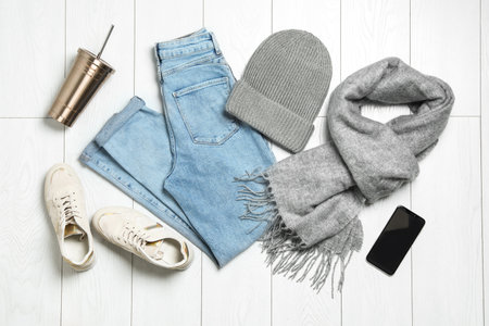 Flat lay composition with stylish clothes on white wooden background