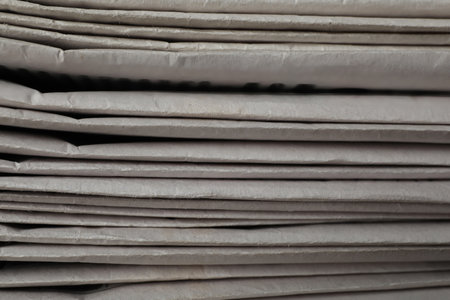 Stack of newspapers as background, closeup. Journalist's work