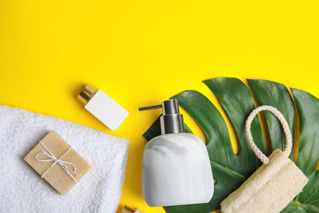 Flat lay composition with marble soap dispenser on yellow background. Space for text