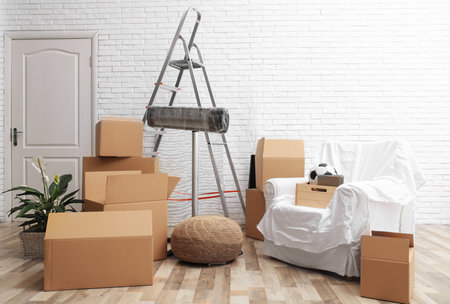 Cardboard boxes and household stuff in the living room. moving day