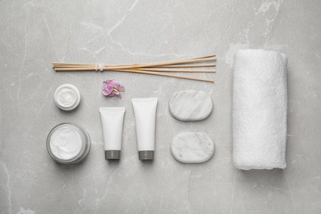 Flat lay composition with cosmetics on gray marble table. spa treatmentの写真素材