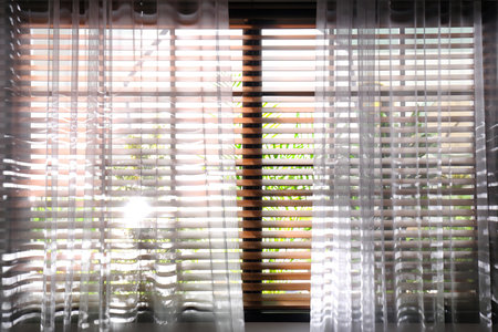 Window with beautiful curtains and blinds, closeupの写真素材