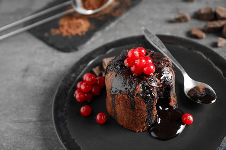 Delicious warm chocolate lava cake with berries on gray table, closeupの写真素材