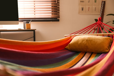 Colorful hammock with soft pillow indoors, closeupの写真素材